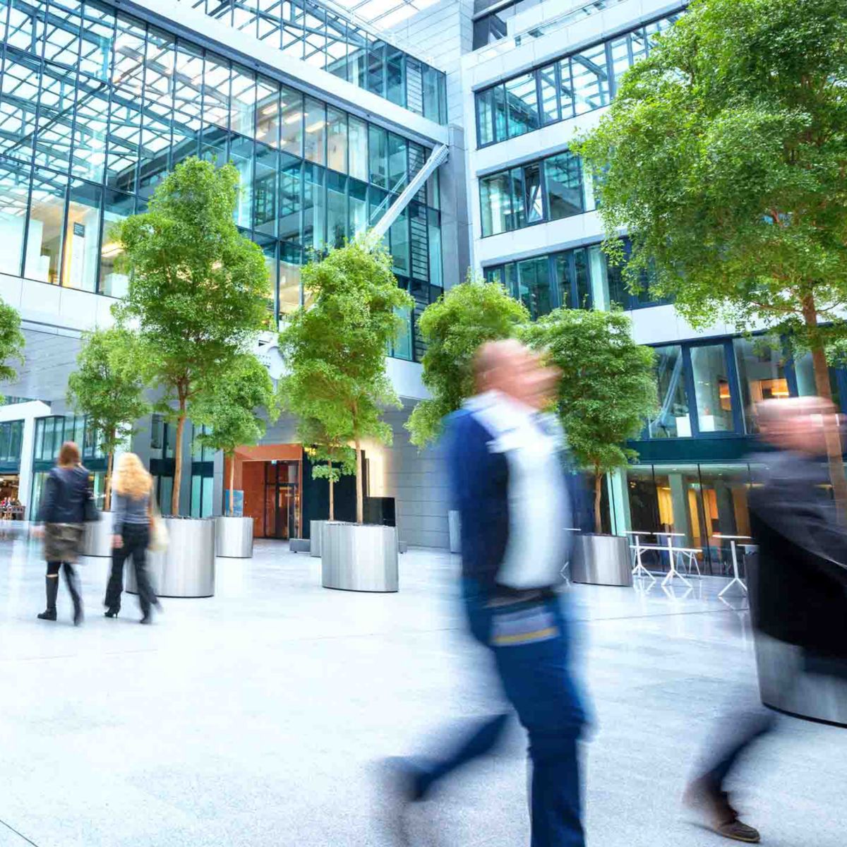 blurred business people walking in a business park