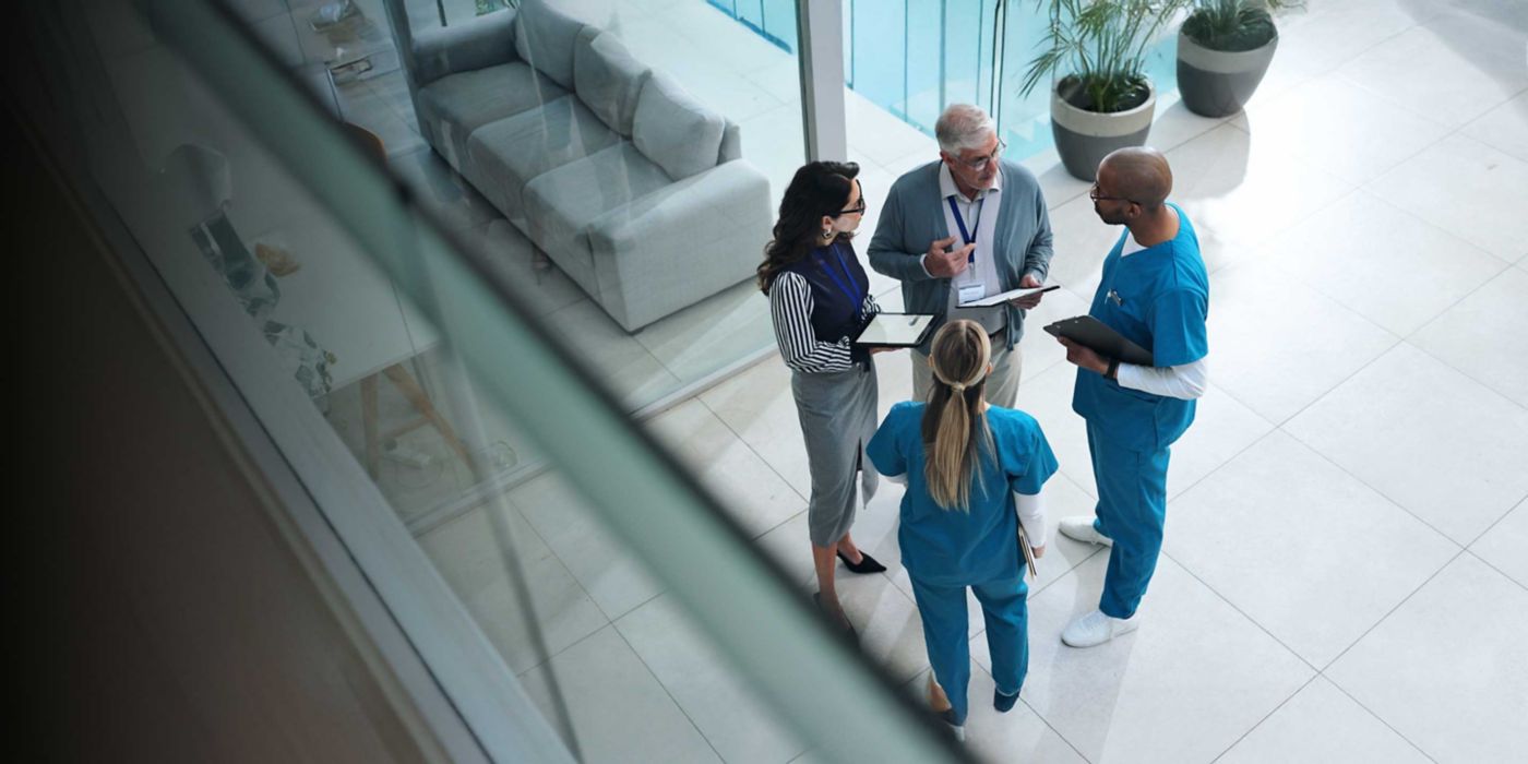 Doctors, medical team and tablet with discussion, advice and above for surgery or patient records. People, tech and nurse for professional opinion, help and results in healthcare, clinic or hospital