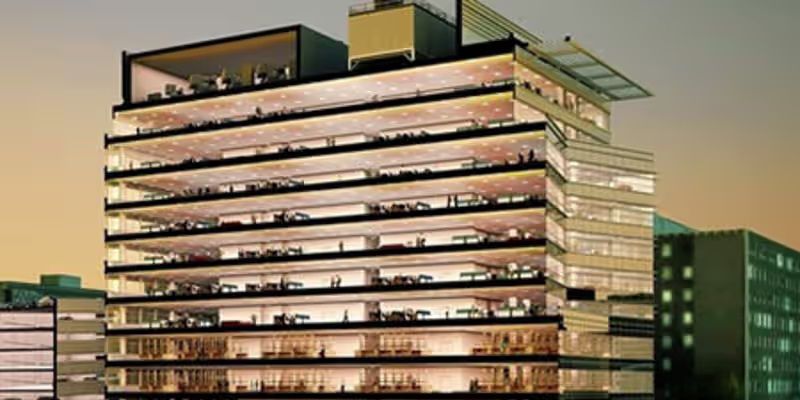 Discover a striking view of a multi-story office building with glass facades and illuminated interiors. Perfect for themes related to corporate life, architecture, or urban development.