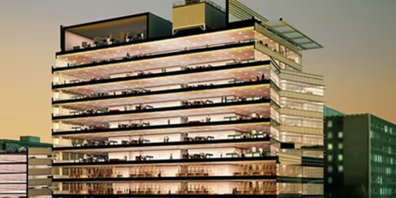 Discover a striking view of a multi-story office building with glass facades and illuminated interiors. Perfect for themes related to corporate life, architecture, or urban development.