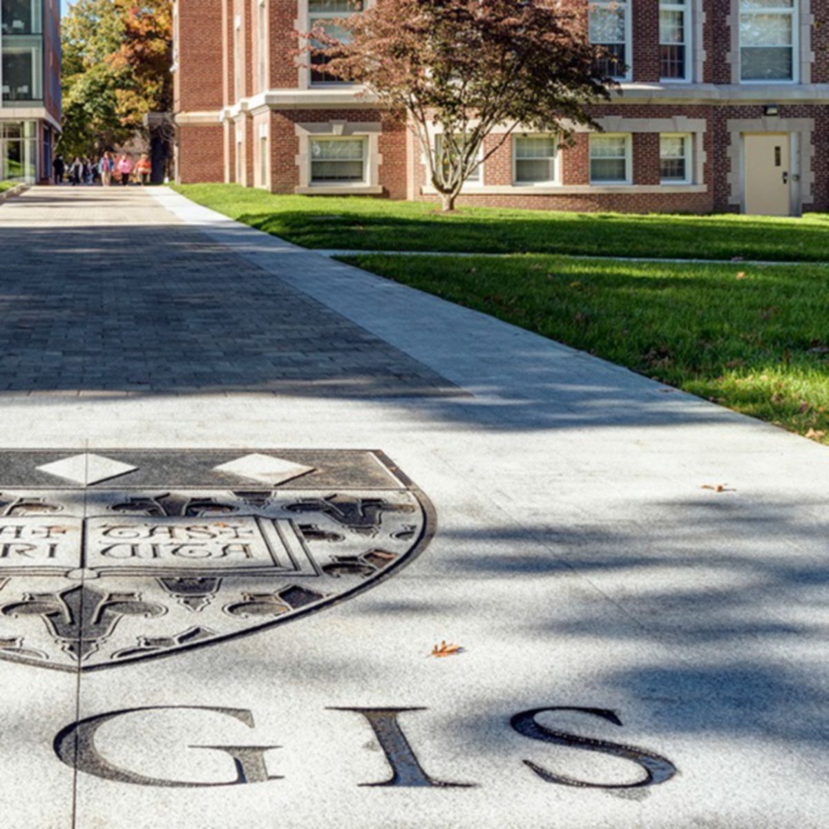 Regis College logo displayed on the ground at the entrance of the campus