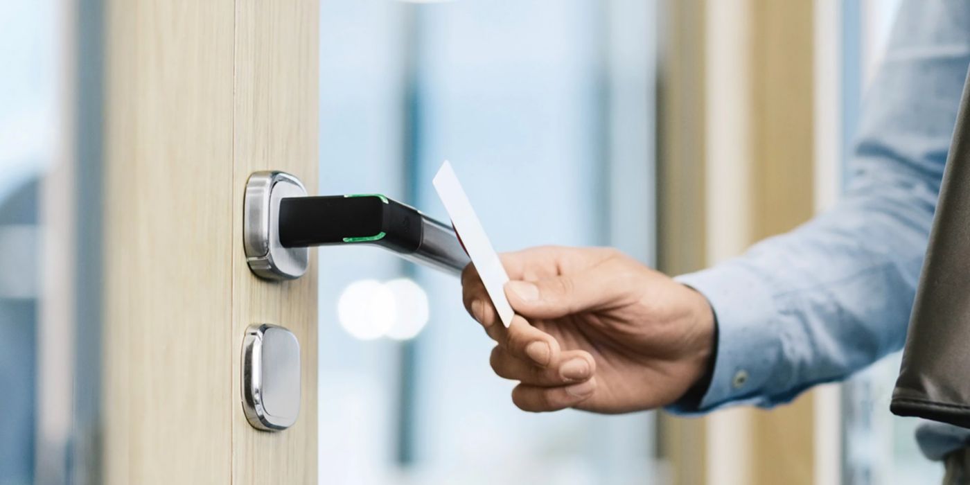 Close-up of a contactless access control system using a smart card and electronic door handle, enabling secure and convenient building entry management.