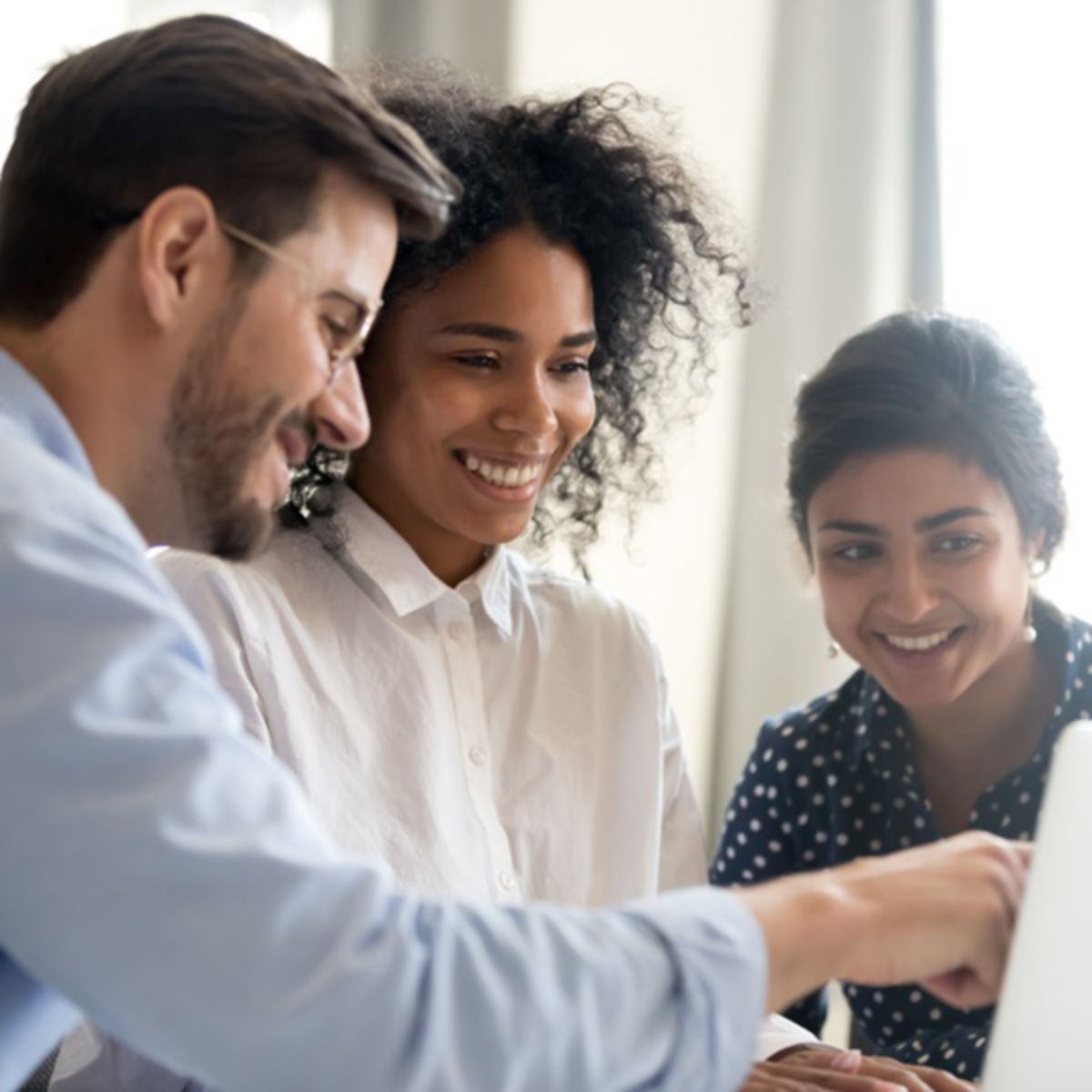 People sharing ideas in front of a monitor