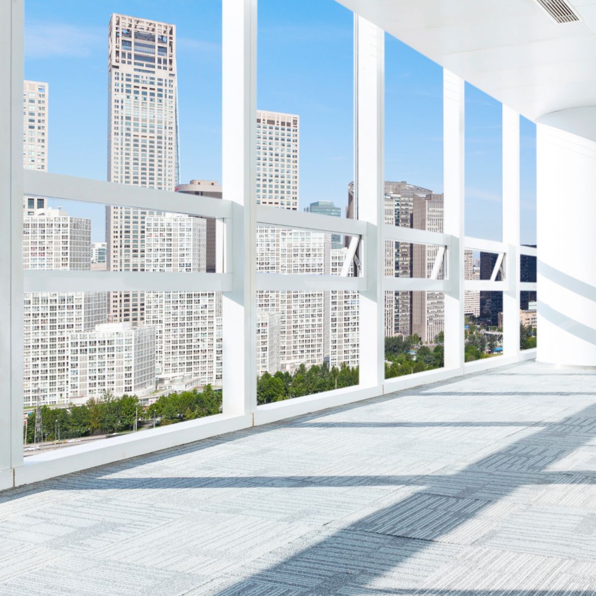 View at tall buildings from room with big windows