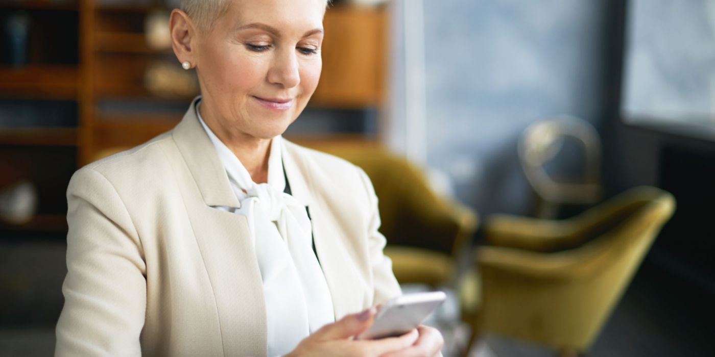 Female real estate agent holding mobile phone