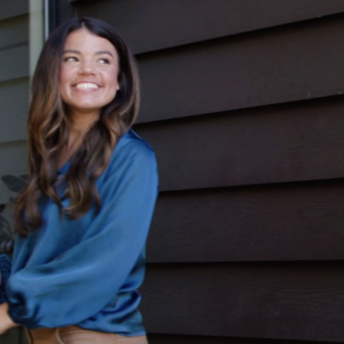 Young adult female real estate opening lockbox with ekey app for showing with female client