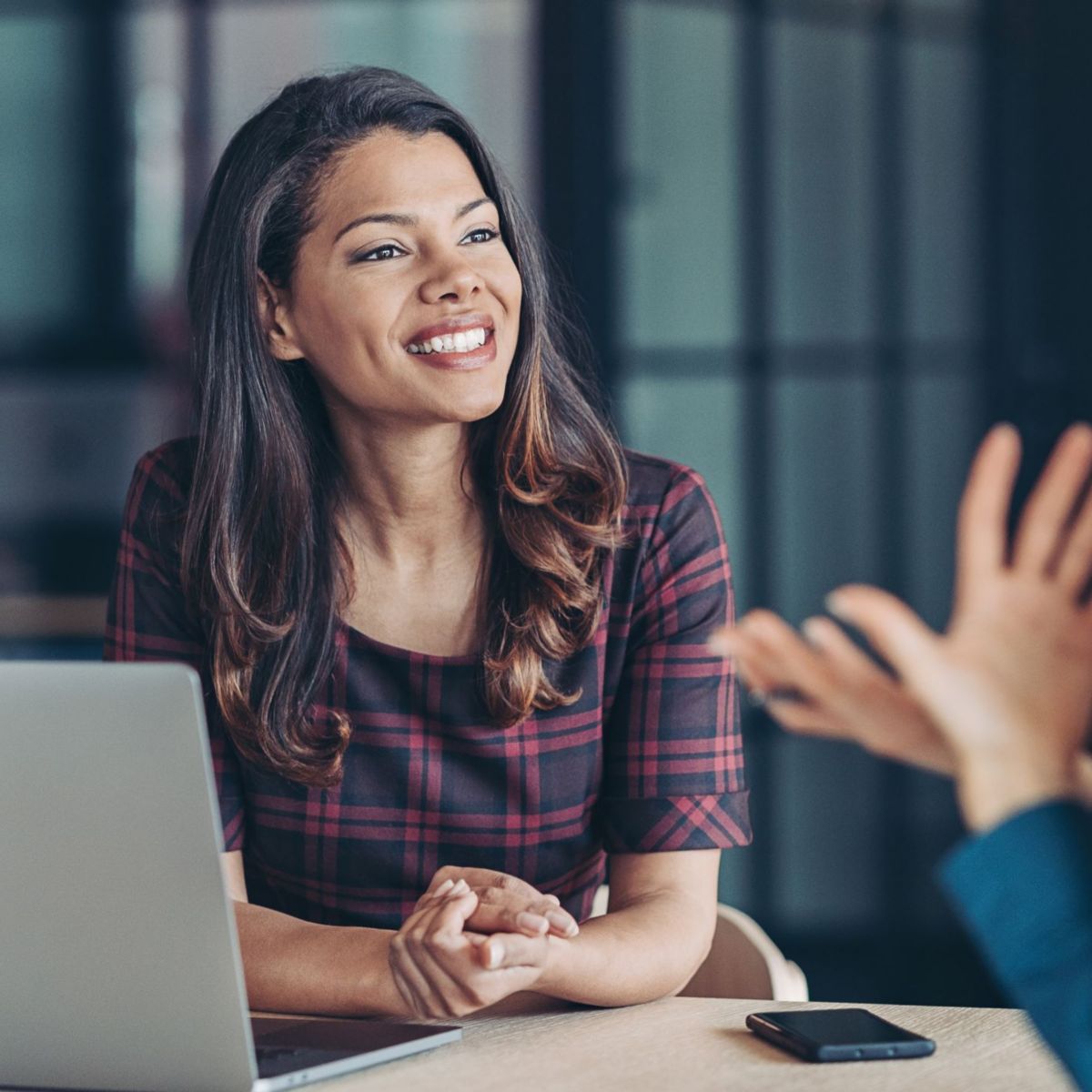 Two female business women talking in office