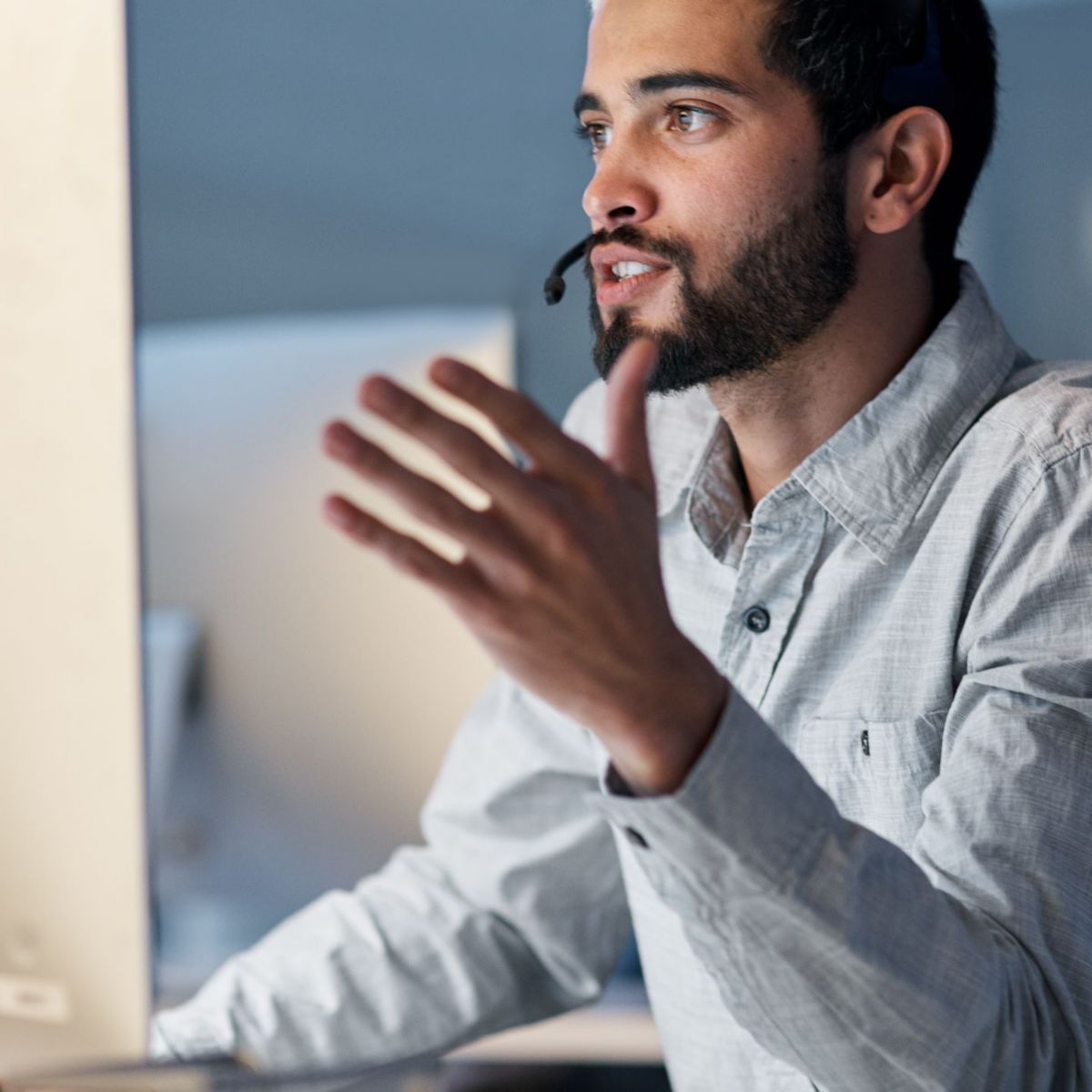 Young man with headset at a computer