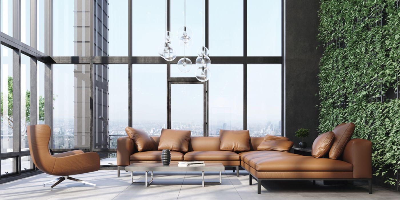Modern living room, brown furniture, lush green accents.