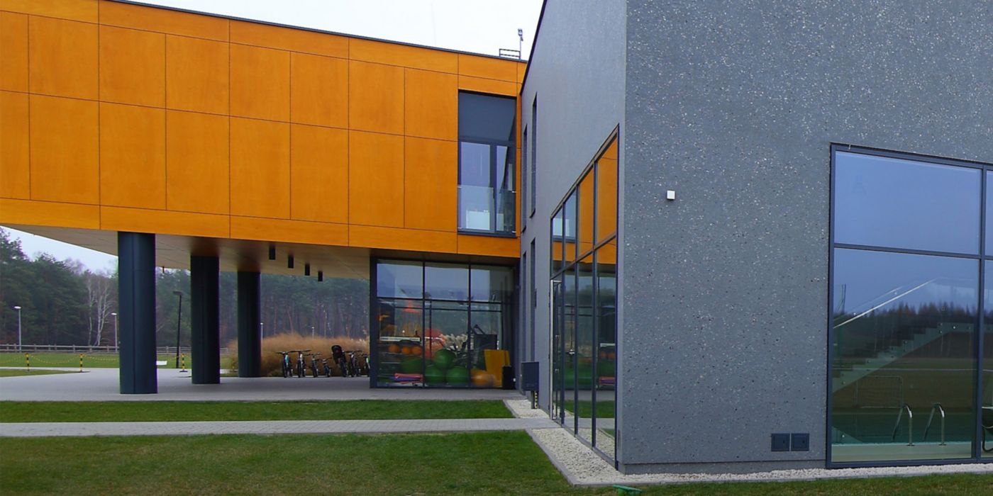 Explore this modern community center featuring bold exterior panels, expansive glass walls, and innovative architectural design.