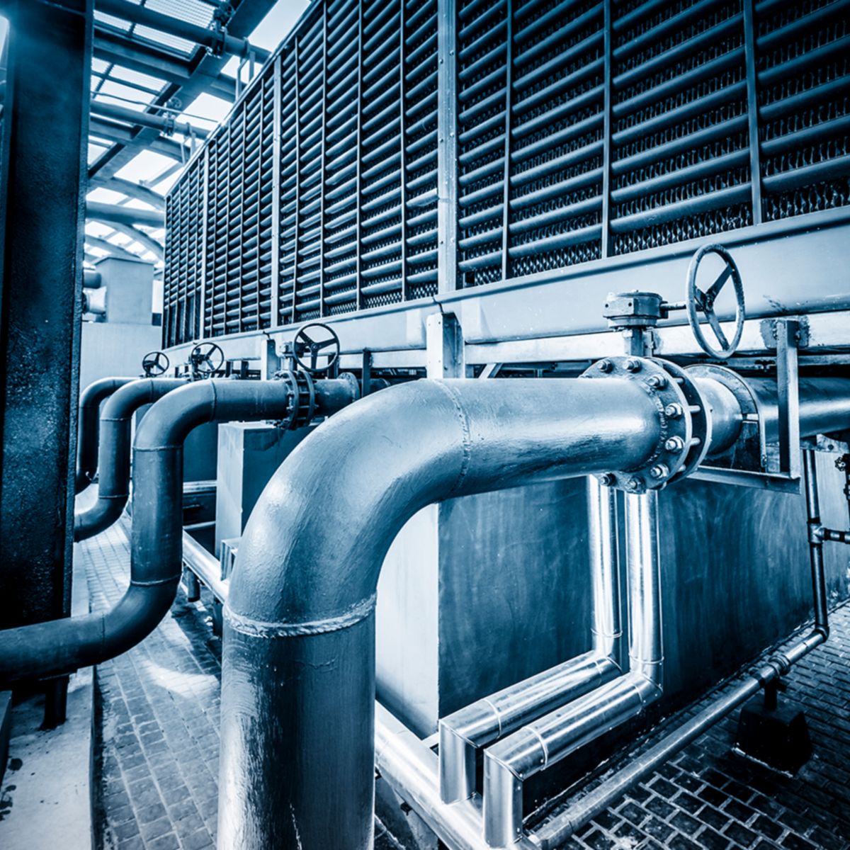 Commercial HVAC system with extensive piping and heat exchange infrastructure, highlighting thermal solutions for efficient temperature control and energy management in large facilities.