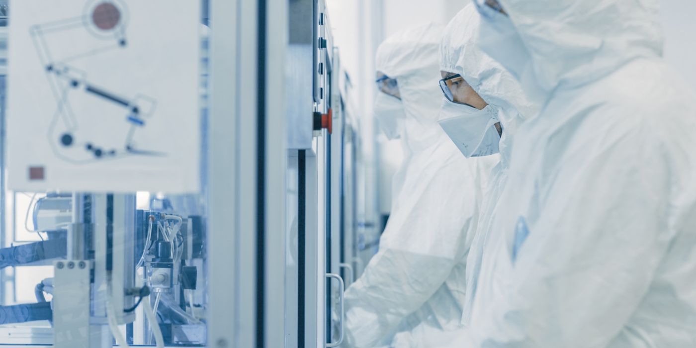 On a Factory Team of Scientists in Sterile Protective Clothing Work on a Modern Industrial 3D Printing Machinery. Pharmaceutical, Biotechnological and Semiconductor Creating / Manufacturing Process
