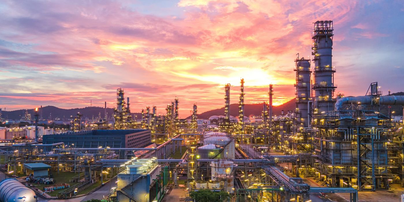 Industrial view at oil refinery plant form industry zone with sunrise and cloudy sky.