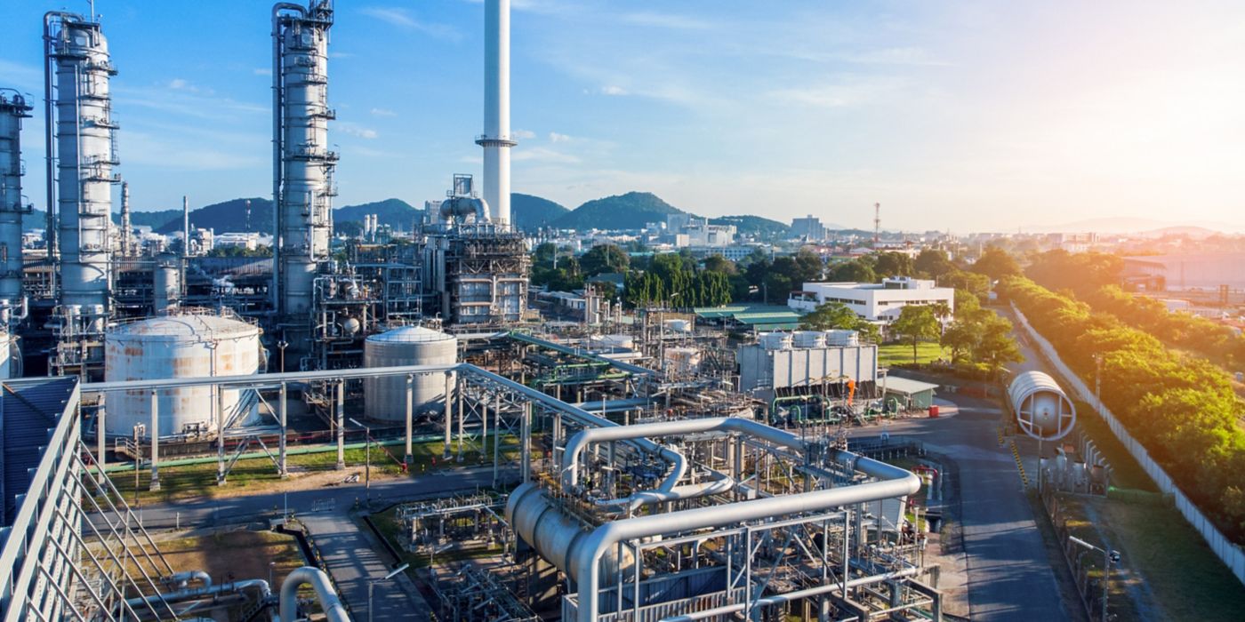 Aerial view of chemical oil refinery plant, power plant on blue sky background.