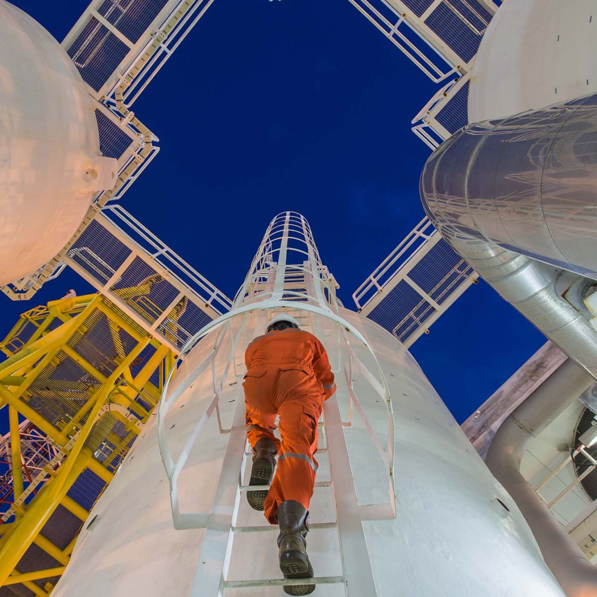 Engineering climb up to oil and gas process plant to observer gas dehydration processing in night shift