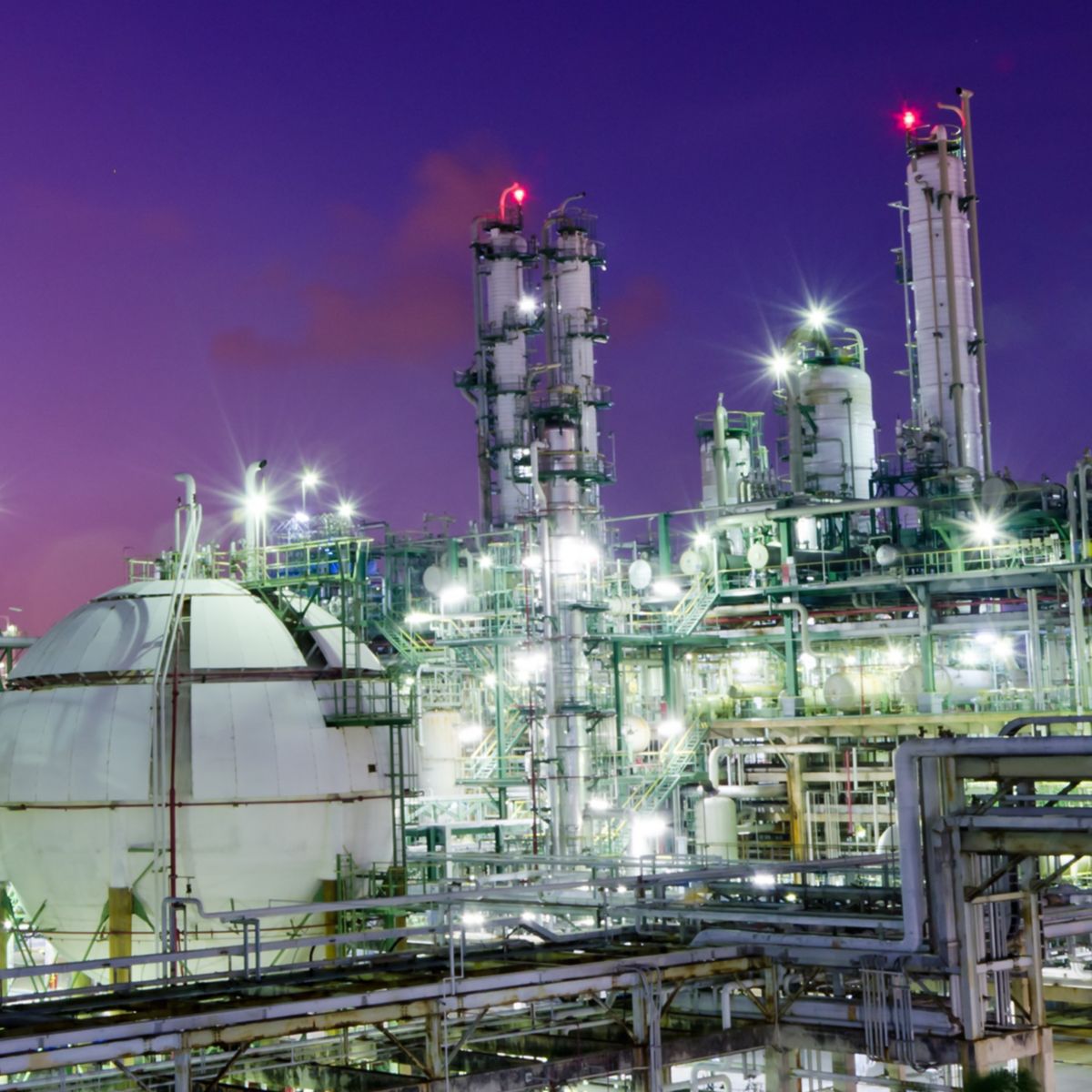 Gas storage spheres tank in petrochemical plant at night