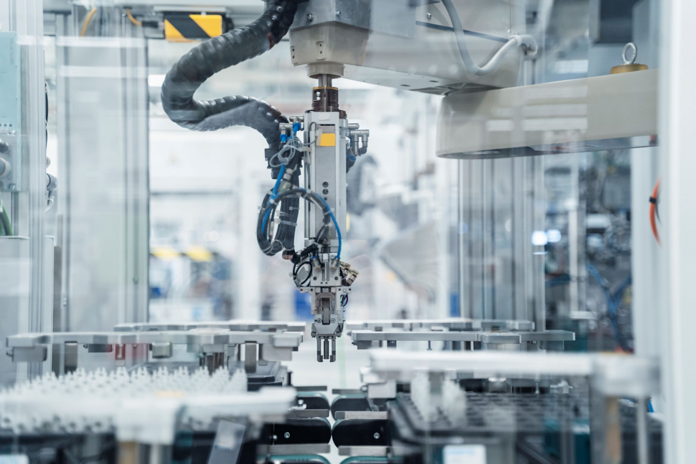 Close-up of a robotic arm in a modern manufacturing facility, showcasing precision automation in action.