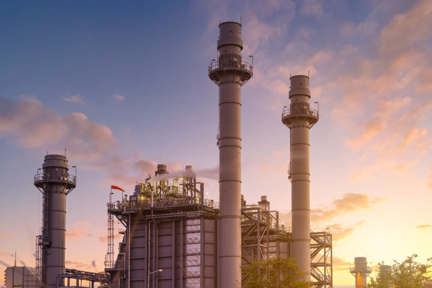 Industrial facility with combustion stacks and processing systems, highlighting efficient fuel use, emissions control, and optimized combustion performance.