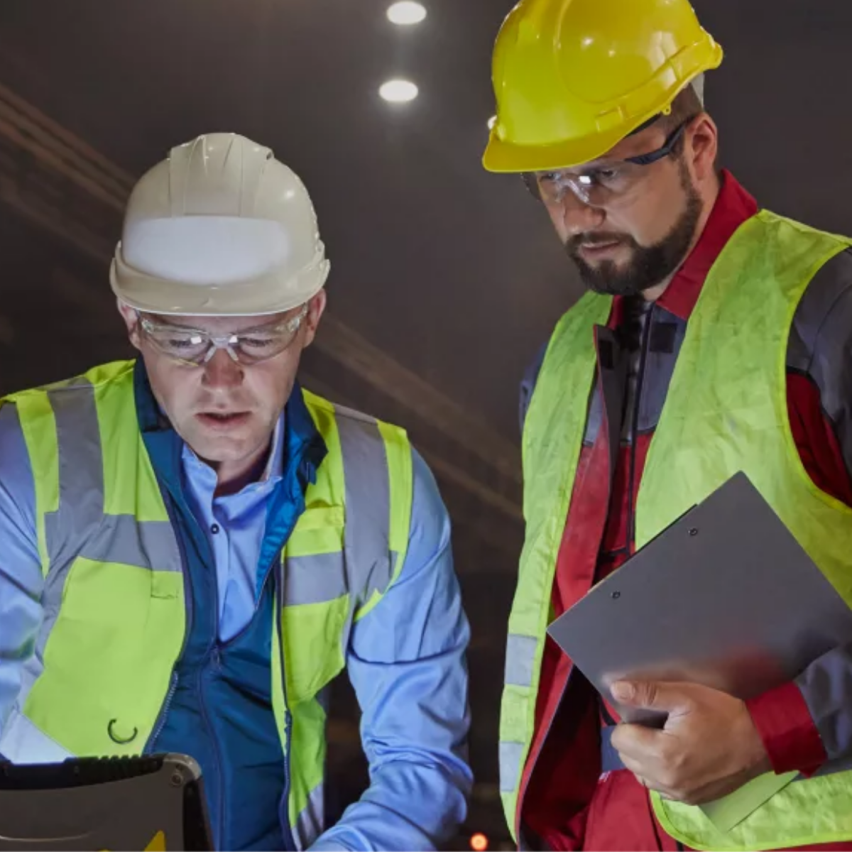 Industrial personnel using digital tools and protective equipment to monitor combustion systems, ensuring safety, efficiency, and reliable thermal performance in operations.
