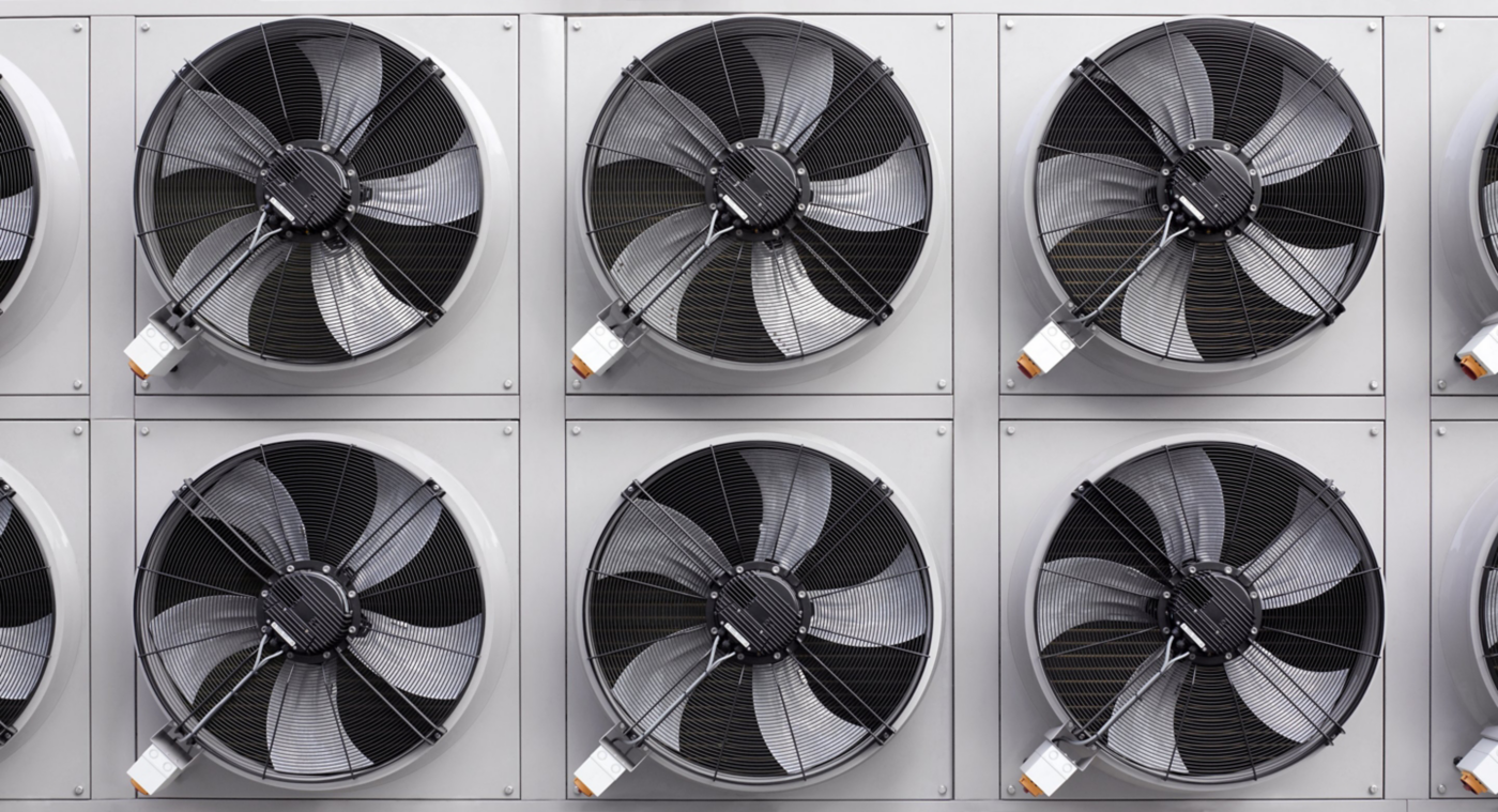 A geometric, straight-on view of multiple industrial HVAC cooling fans mounted in a symmetrical grid pattern for climate control.