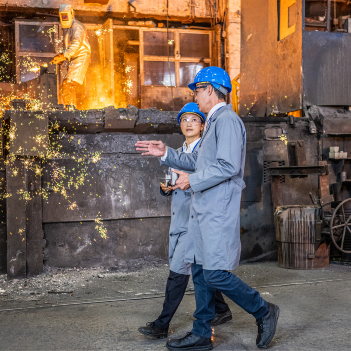 Industrial personnel overseeing molten metal processing in a foundry, highlighting high-temperature operations, safety practices, and process optimization in heavy manufacturing.