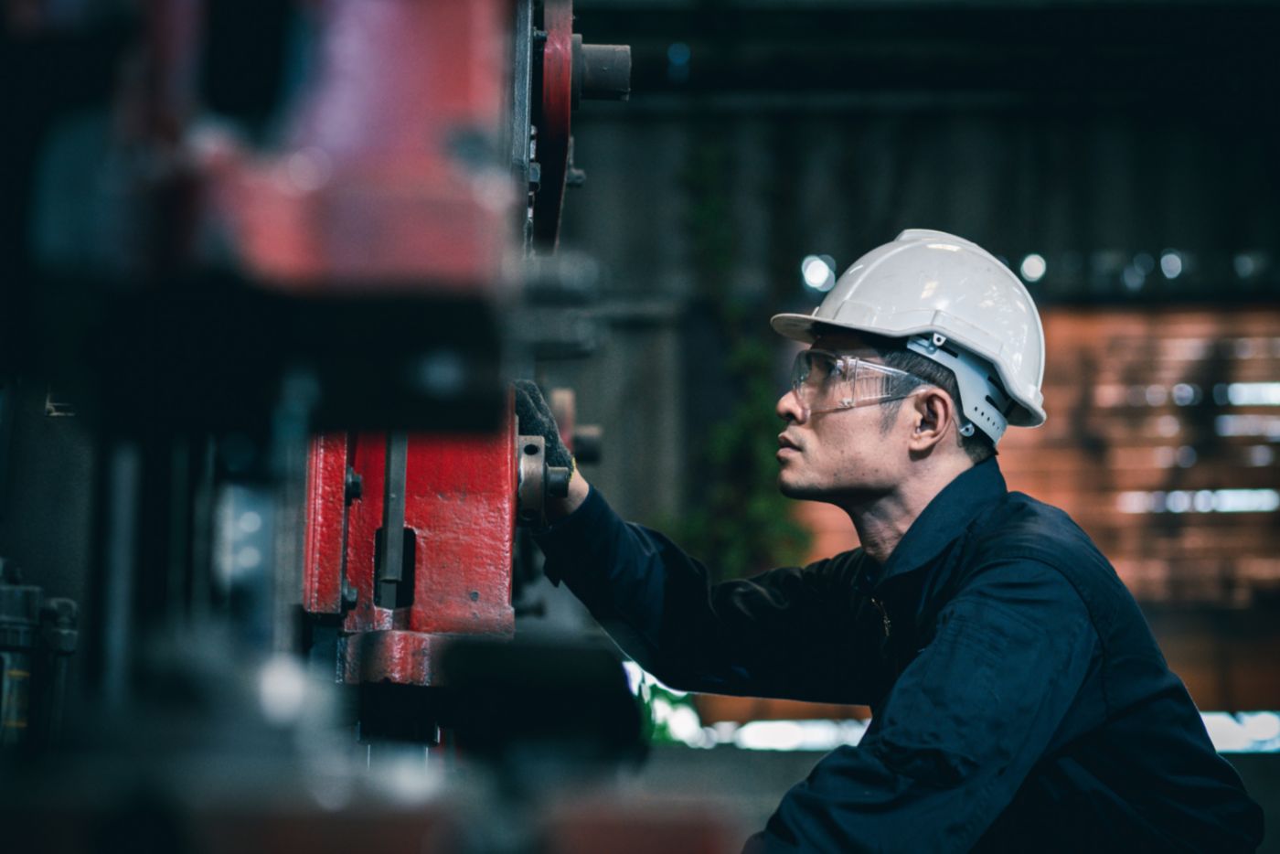 Technician inspecting industrial equipment used in thermal systems, supporting reliable operation, preventive maintenance, and efficient heat management in demanding environments.
