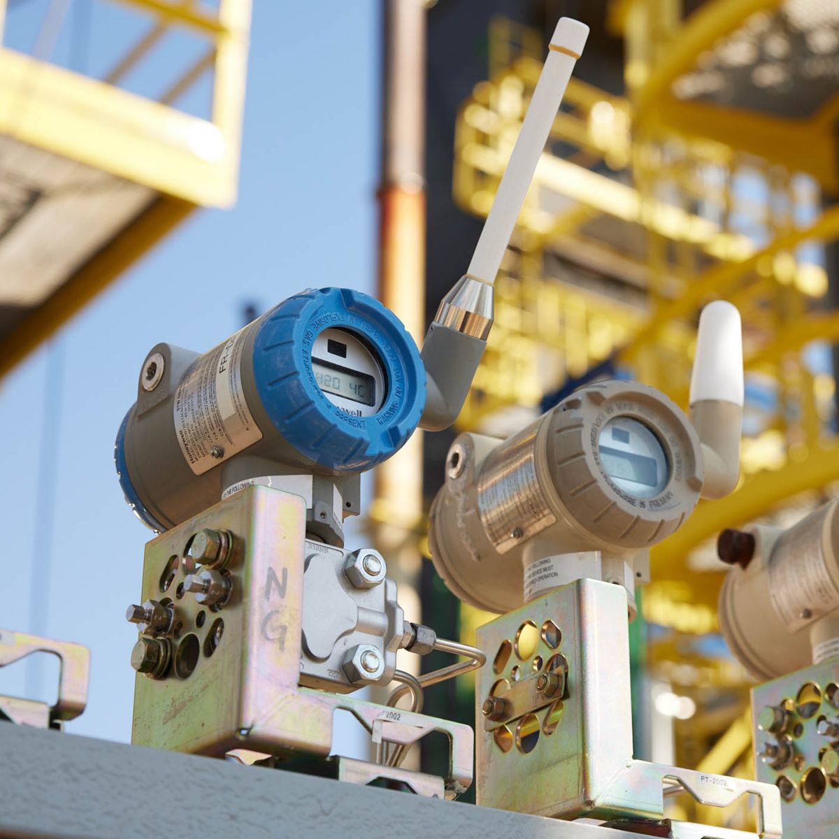 Four electronic gas monitors fixed on cement slab outdoors