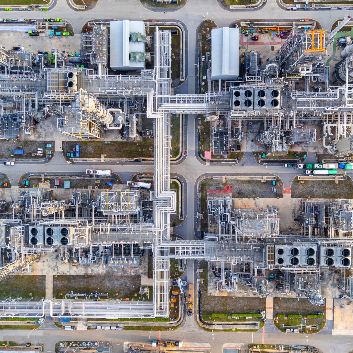 A direct overhead view capturing the intricate pipe networks and industrial structures of a sprawling petrochemical processing facility.