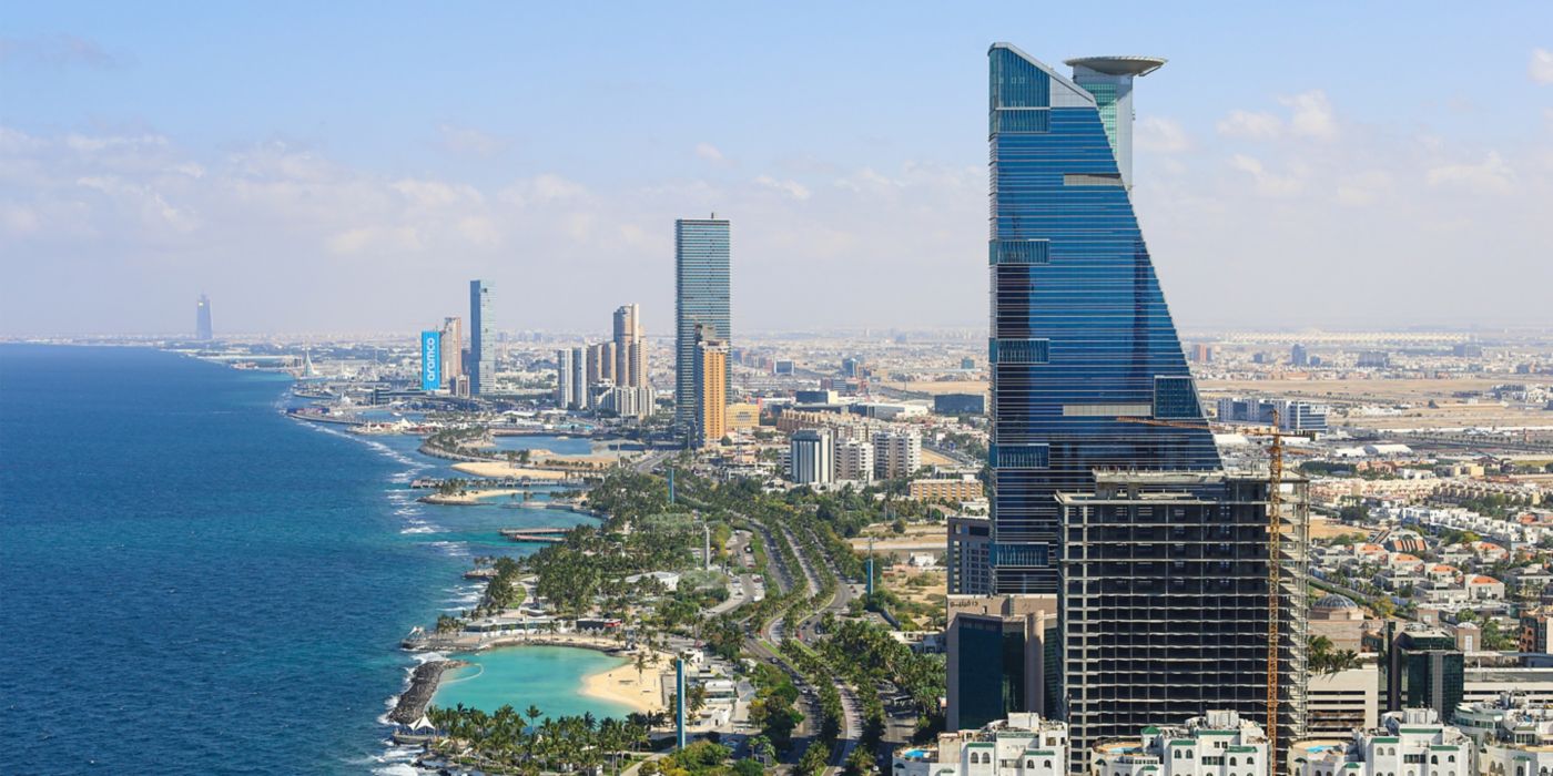 Aerial view of Jeddah skyline with modern towers along the Red Sea waterfront.