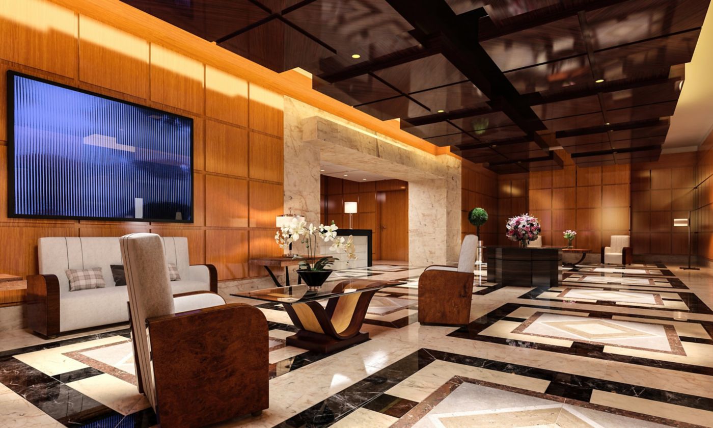 A sophisticated office building lobby featuring warm wood paneling, elegant marble flooring, and contemporary lounge seating with upscale decorative accents.