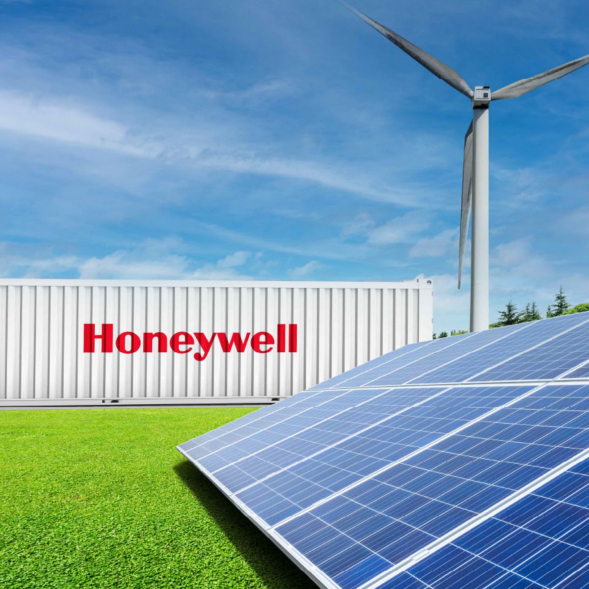 Solar panels and a wind turbine installed on grass near a Honeywell‑branded container, set against a clear blue sky.
