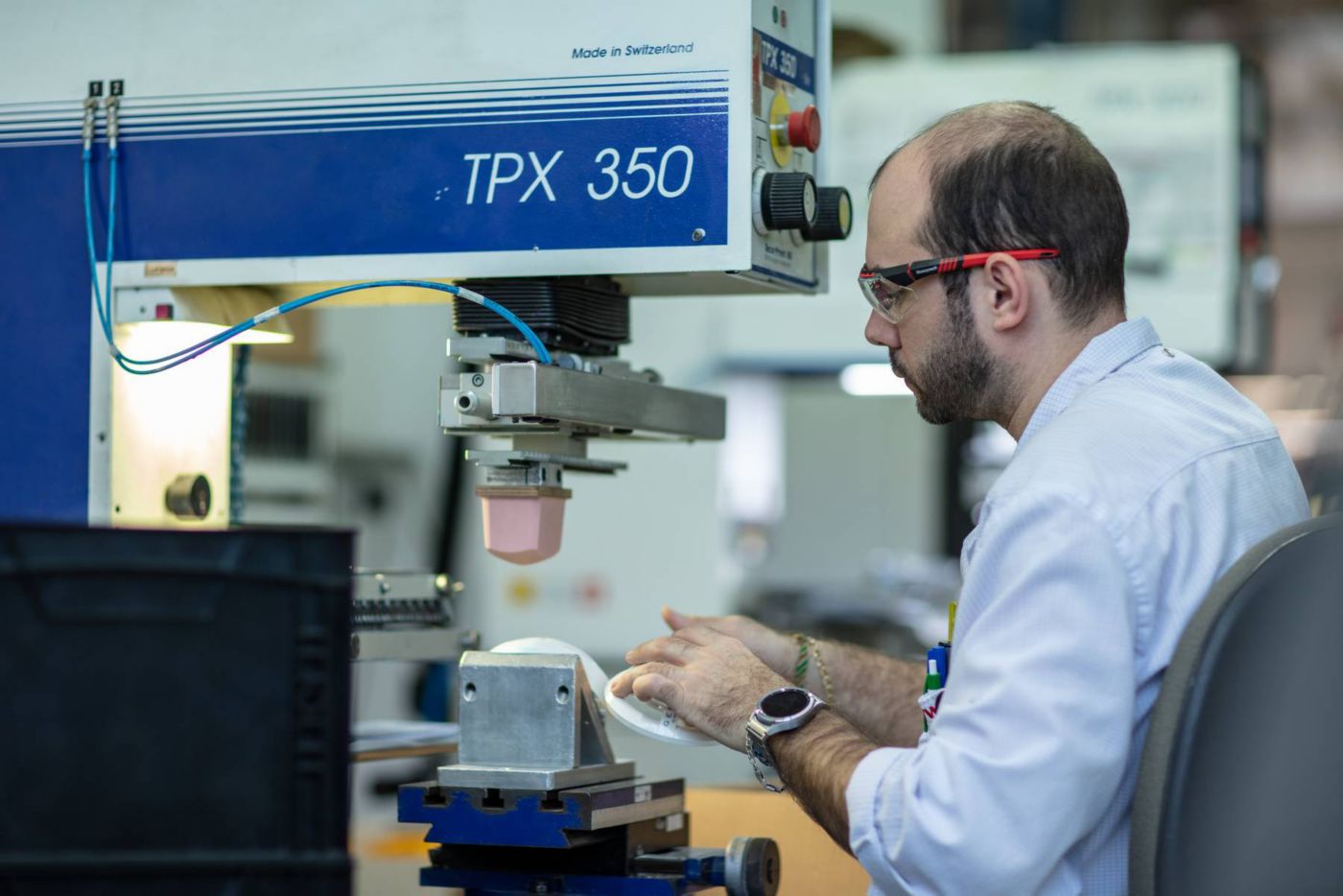 Technician using a tempograph to perform precise material testing and measurement, ensuring accuracy and quality control in industrial applications.