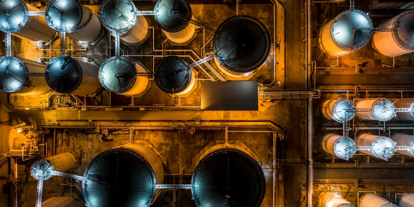 Liquid chemical tank terminal with storage of liquid chemical and petrochemical products tank in an aerial view at night.