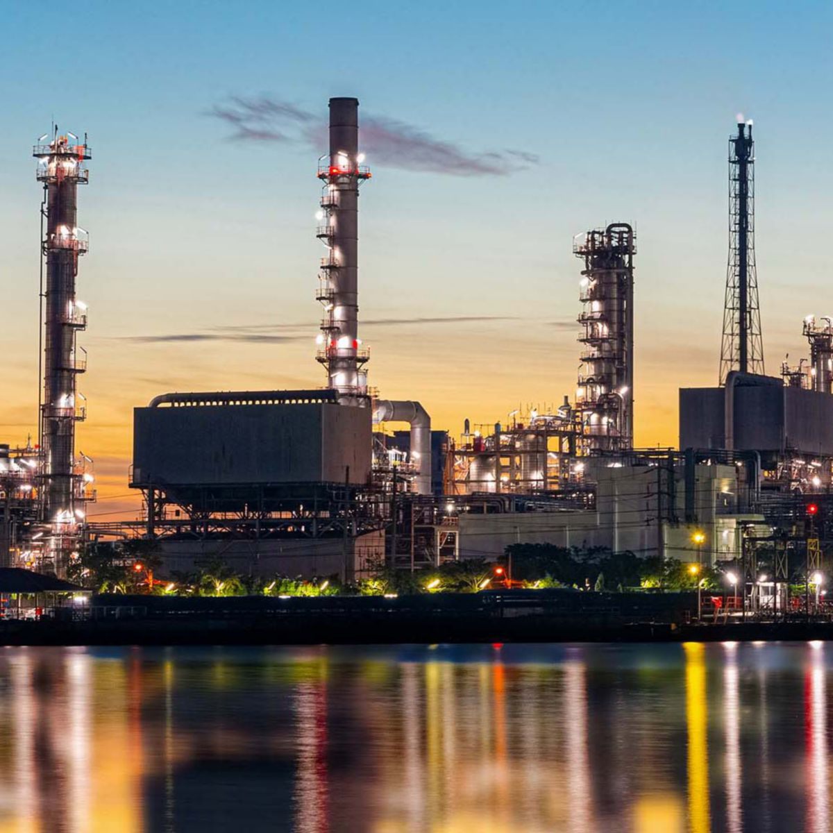 Oil and gas refinery industry plant with glitter lighting and sunrise in the morning, Factory of petroleum industrial, Power plant,Energy power station area. Industry 4.0