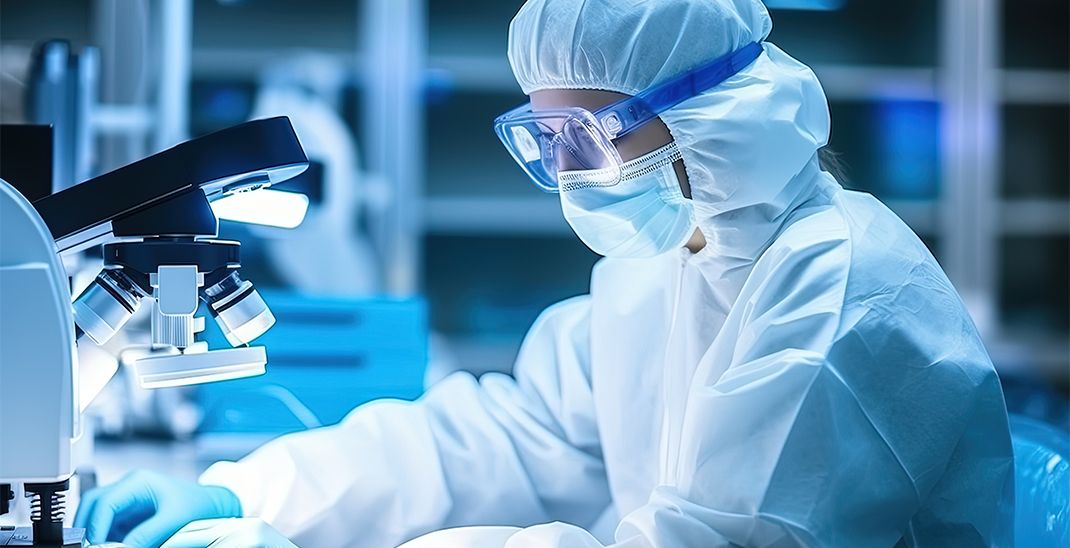Researcher in a protective mask working in a laboratory of a research institute. Creation of innovative medicines and vaccines. Close-up photo.