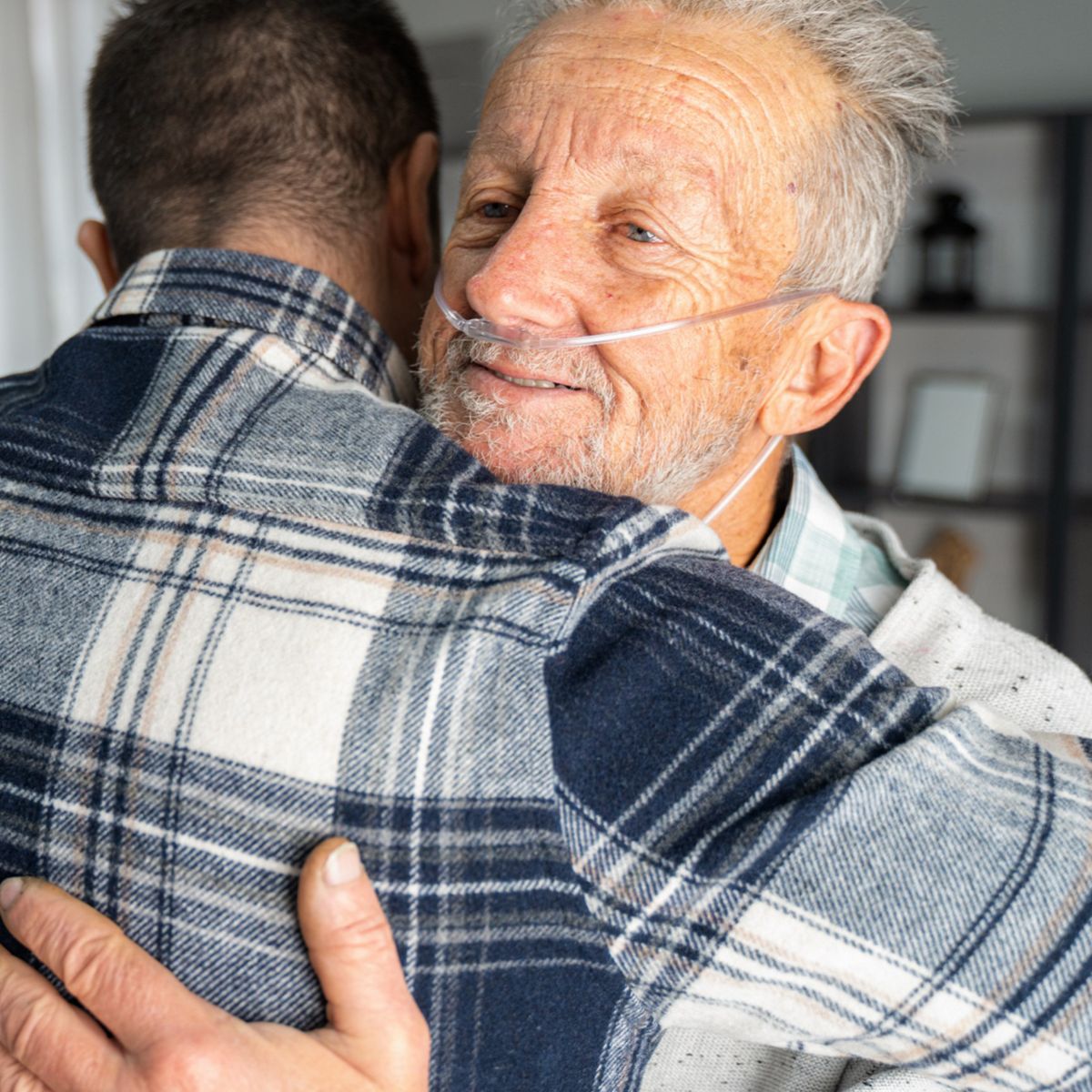 man and his senior father embracing