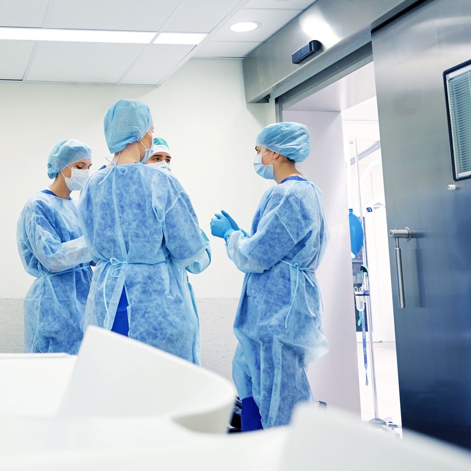 group of surgeons in operating room at hospital