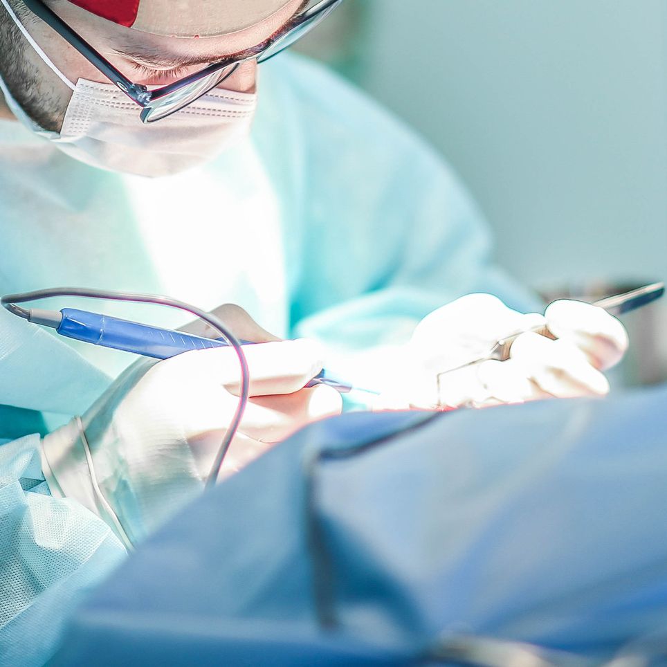 Young male plastic surgeon operates in the operating room of a medical center.