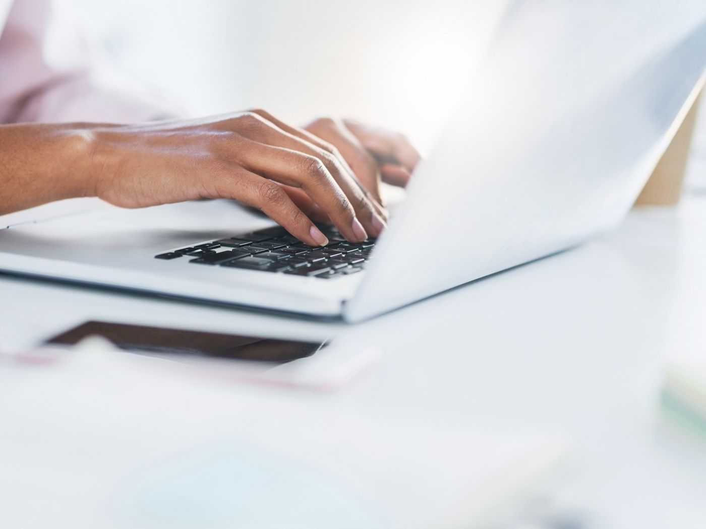 Closeup shot of an unrecognizable woman working on a laptop in an office
